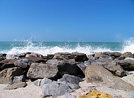 ocean crashes over rocks